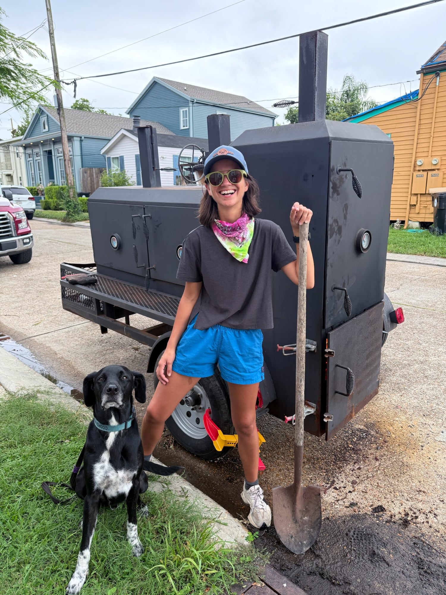 Coop's Table owner Bunkie and dog Cooper in front of smoker